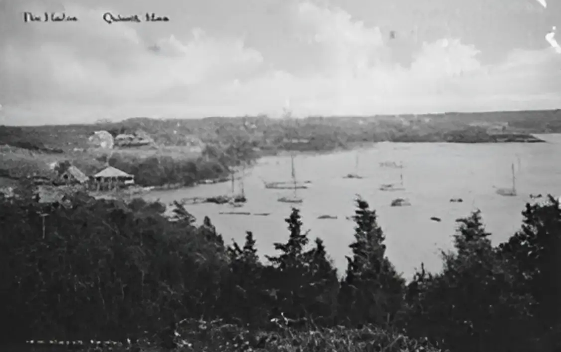 A black and white photo of boats in the water.